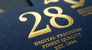 Macro shot of high-precision digital gold foil on textured paper, showing the fine details of premium label stamping quality by Liangyu Foil.
